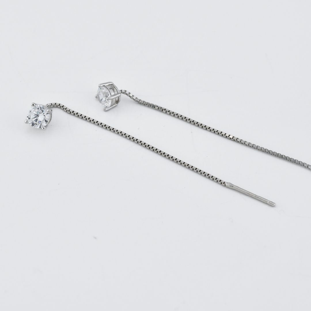 Orecchini con zircone sfaccettato su griffe di zirconi e filo a cascata